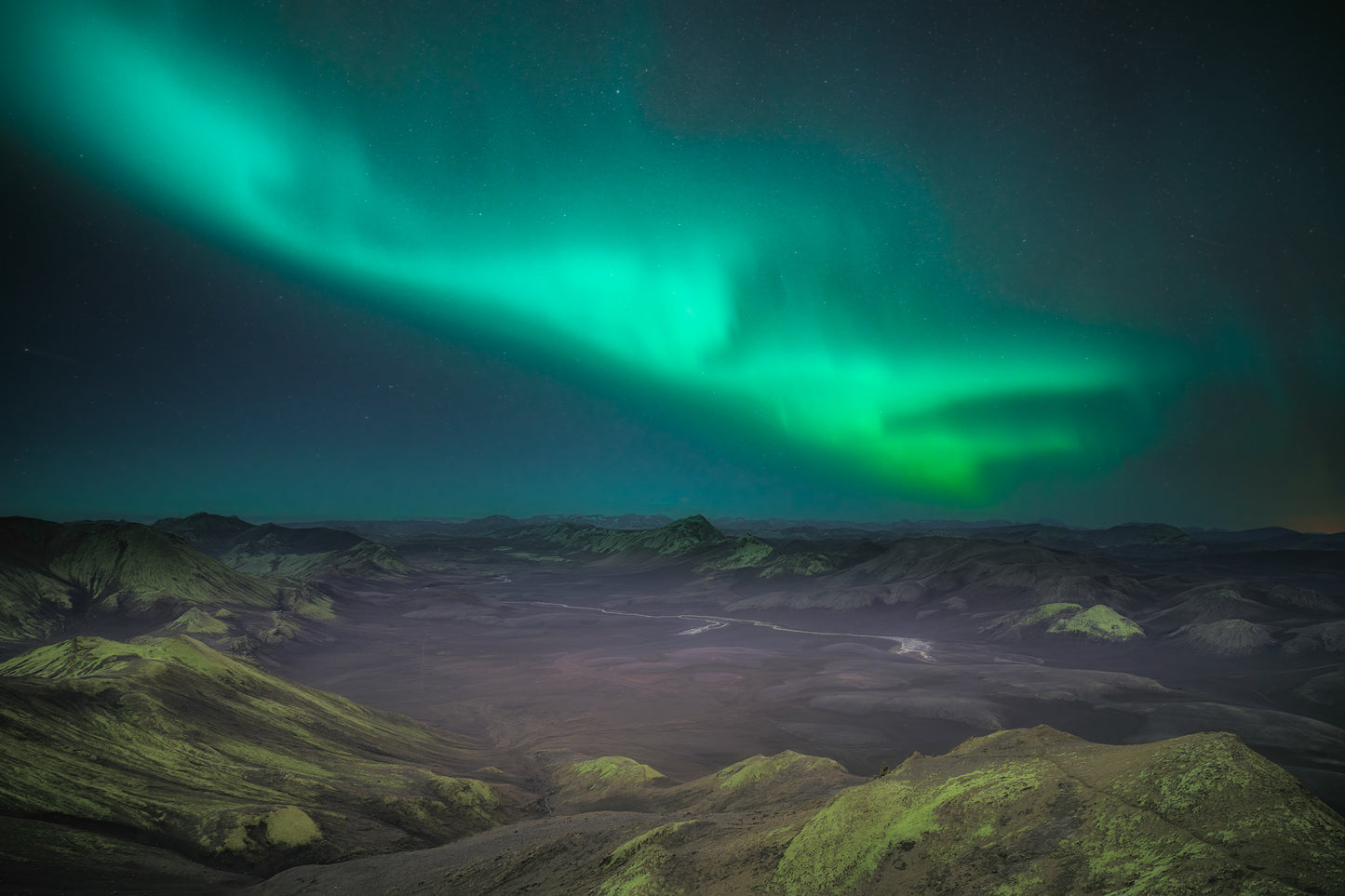 Langisjor Region Iceland Highlands Aurora borealis over a mountainous landscape