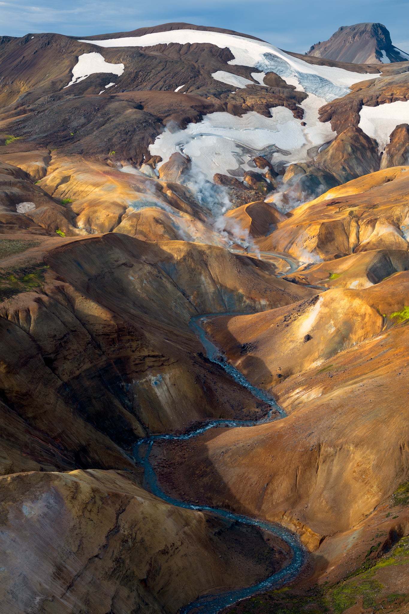Kerlingarfjoll. Majestic landscape of rugged mountains with a river flowing through them.