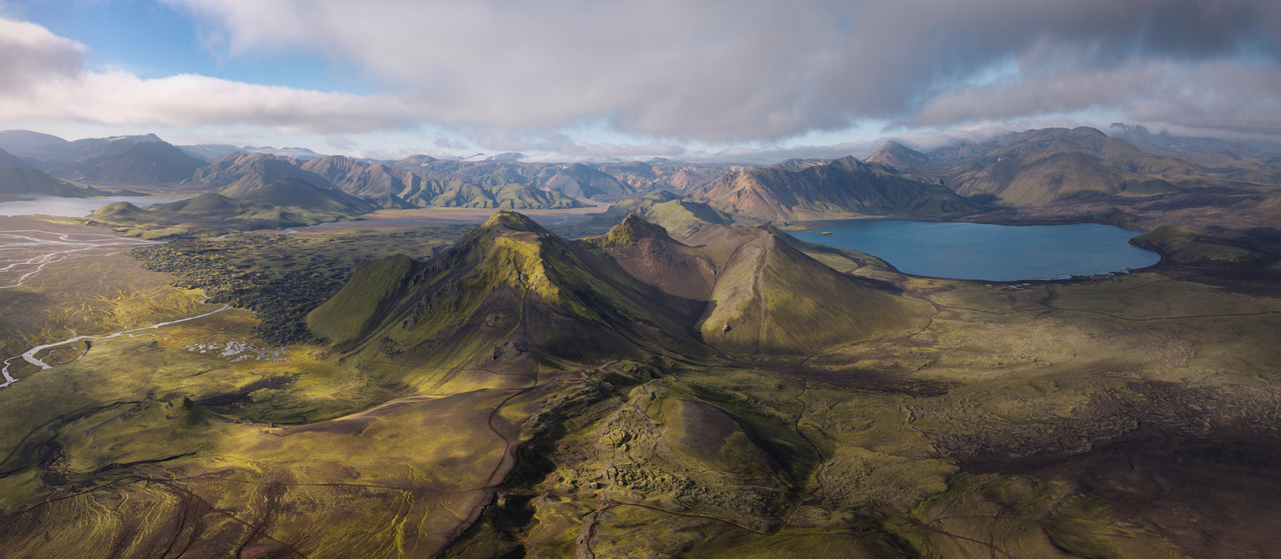 Iceland Highlands. Aerial view of a mountainous landscape with a lake and green valleys.