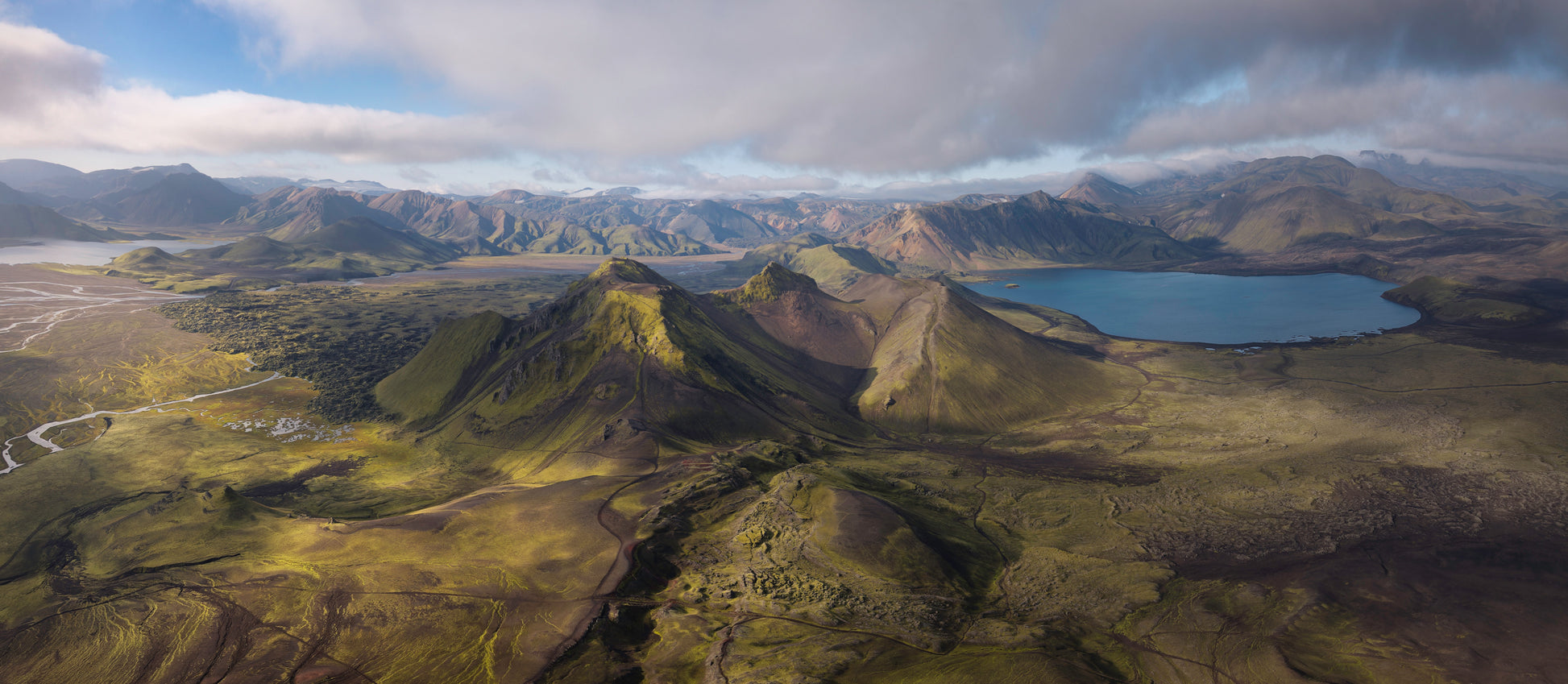 Iceland Highlands. Aerial view of a mountainous landscape with a lake and green valleys.