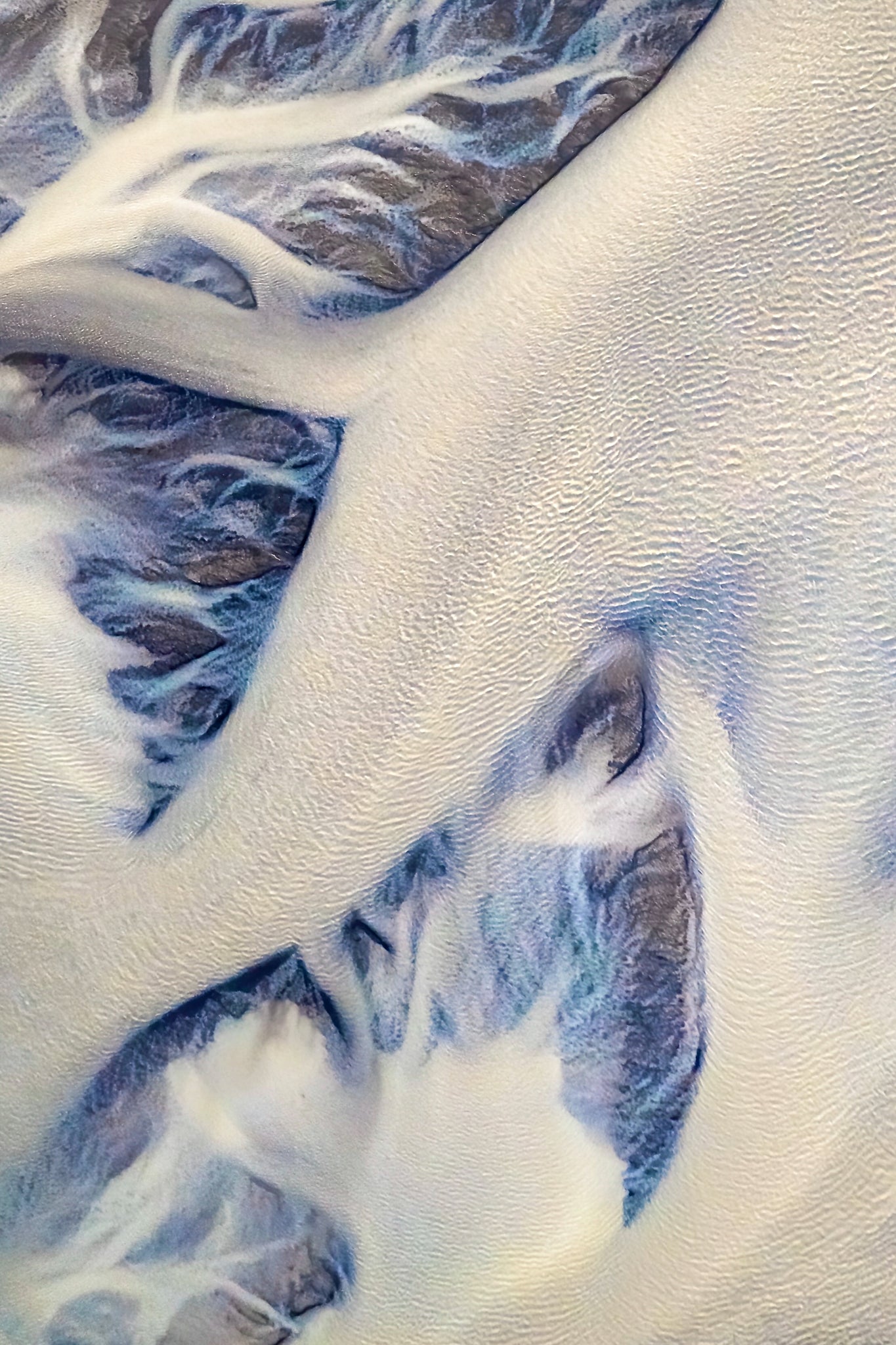 Iceland Glacial river. Close-up of textured white and blue fabric